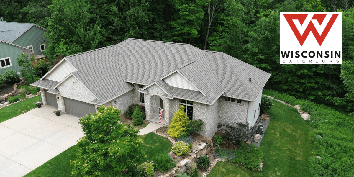 Aerial view of a modern home with landscaping and a Wisconsin Exteriors logo